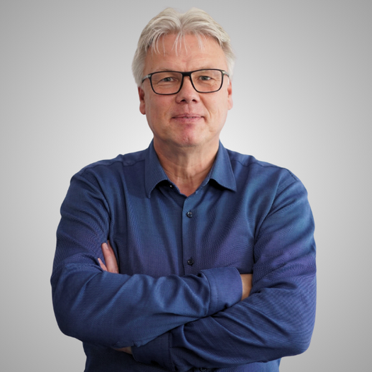 Dr. Gerhard Neurauter, VP of Regulatory Competence Center, smiling in a blue shirt
